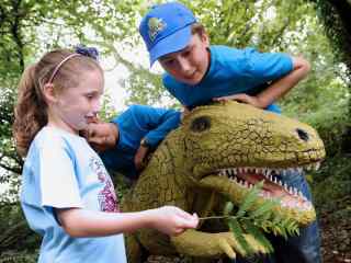 Children playing with a dinosaur