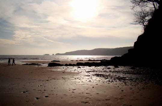 Coastal view with people walking in the distance