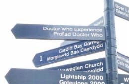 A sign post including a Dr Who experience sign in Cardiff