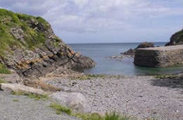 Stackpole Quay with shingle beach and sea