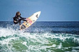 Woman on surfboard riding a wave
