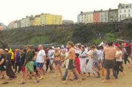 People on the beach waiting for the Tenby Boxing Day swim