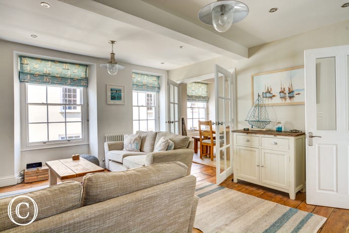 Lounge is separated by glass doors to kitchen/diner