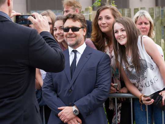 Russell Crowe smiling with fans