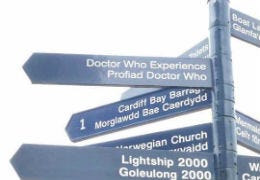 A sign post including a Dr Who experience sign in Cardiff