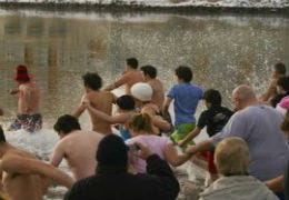 Amateur swimmers running into open water in Saundersfoot