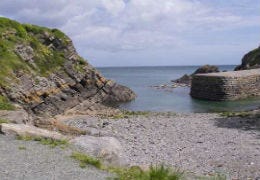 Stackpole Quay with shingle beach and sea