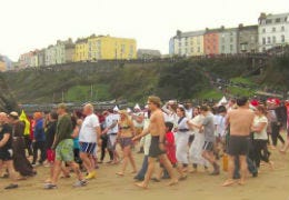 People on the beach waiting for the Tenby Boxing Day swim